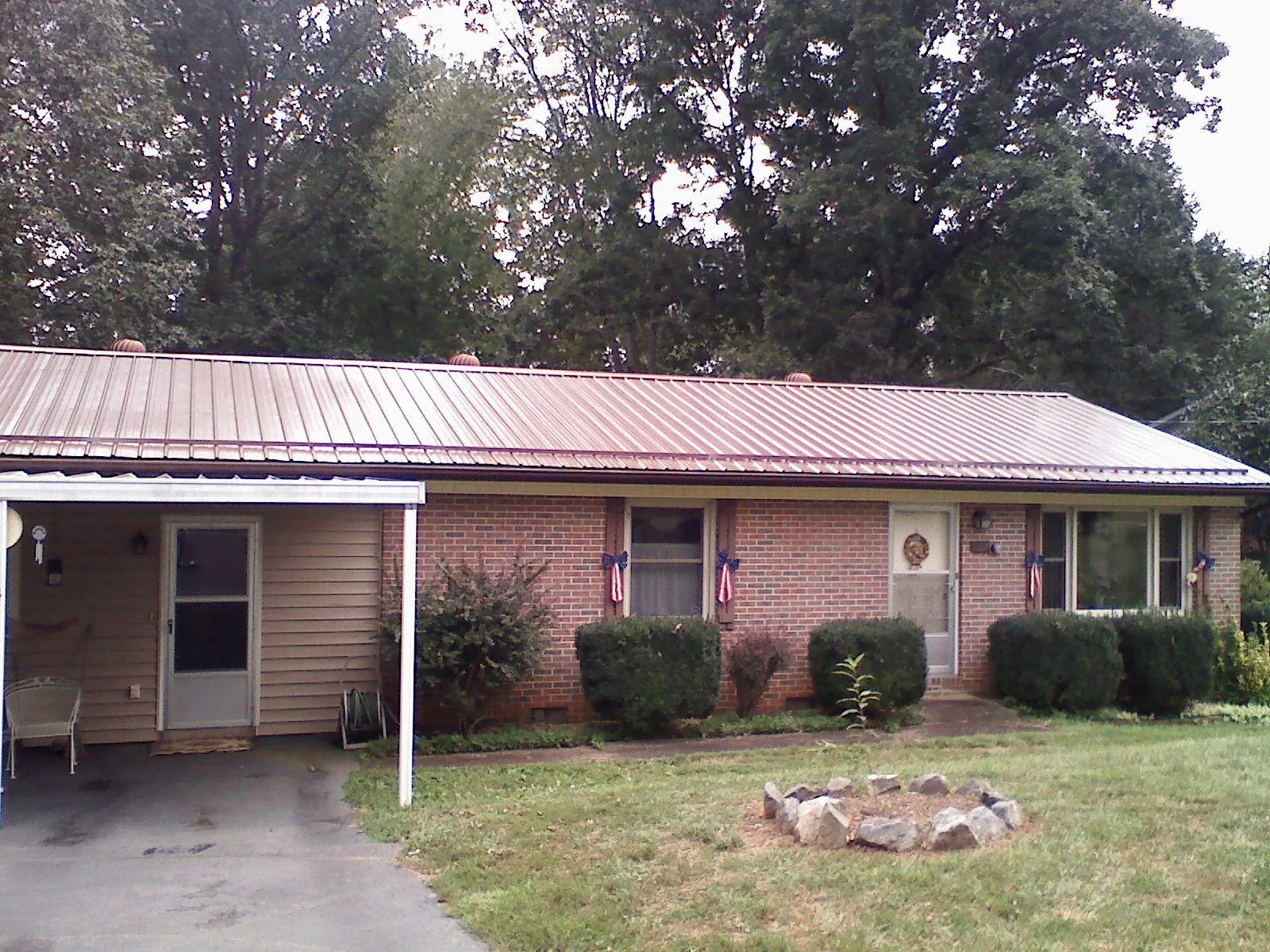 Bronze metal roof and carport on a brick ranch home — Roof Repair work by our crew in Naperville